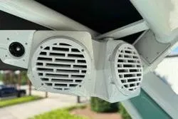 Slide: The Image of Close-up of a 2021 Centurion Ri245 boat's wakeboard rack in a sunny setting. - 14