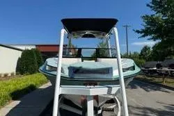 Slide: The Image of 2021 Centurion Ri245 boat on trailer, mint green exterior, parked outdoors. - 5