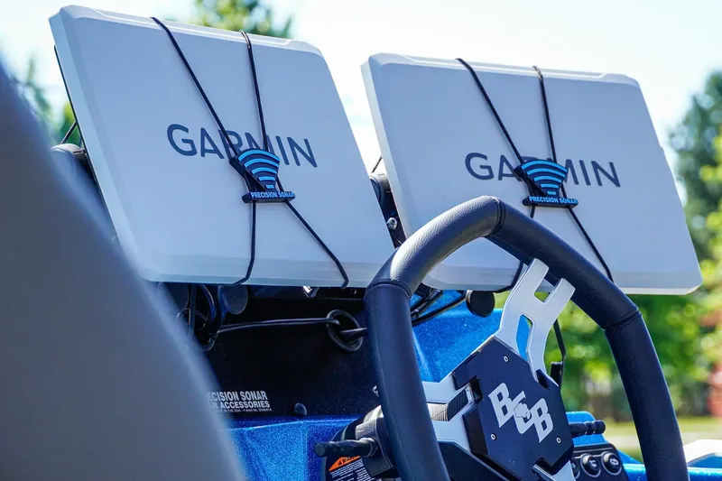 Slide: The Image of 2025 Bass Cat Puma STS dashboard with dual Garmin displays and steering wheel. - 10