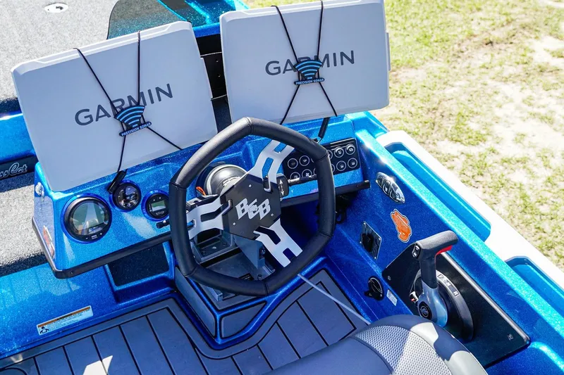 Slide: The Image of 2025 Bass Cat Puma STS boat dashboard with Garmin displays and steering wheel. - 11