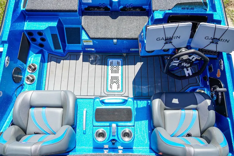 Slide: The Image of 2025 Bass Cat Puma STS boat interior with dual Garmin screens and stylish seating. - 12