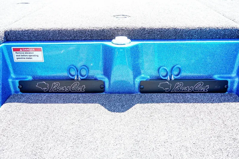 Slide: The Image of 2025 Bass Cat Puma STS boat deck with logo and safety warning label. - 13