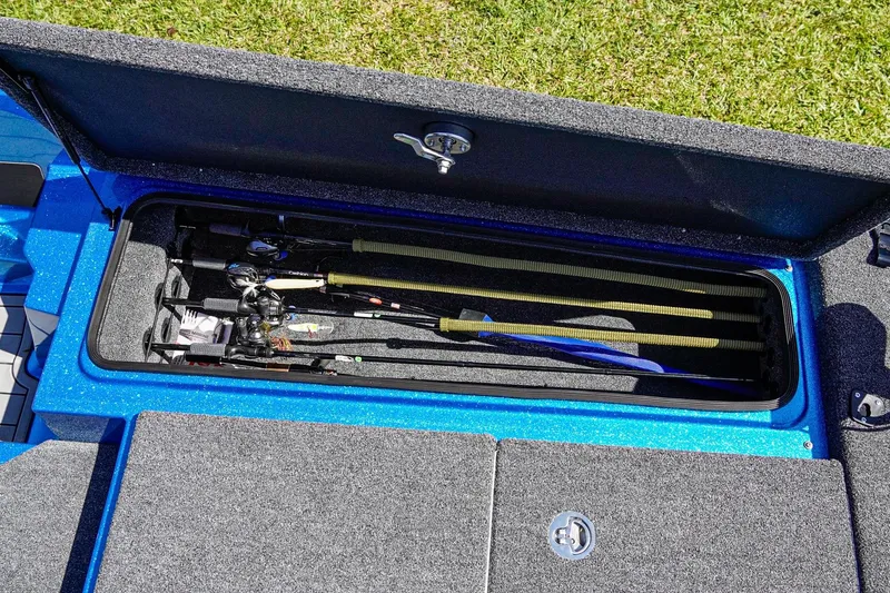 Slide: The Image of 2025 Bass Cat Puma STS boat storage compartment with fishing rods. - 16