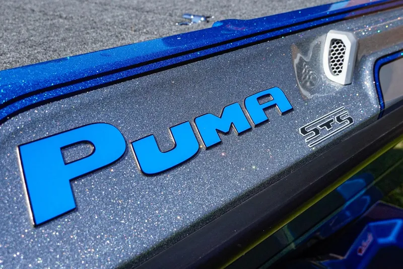 Slide: The Image of 2025 Bass Cat Puma STS boat logo on metallic blue surface. - 21