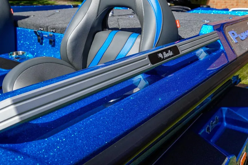 Slide: The Image of 2025 Bass Cat Puma STS boat interior with blue metallic finish and sleek seating design. - 22