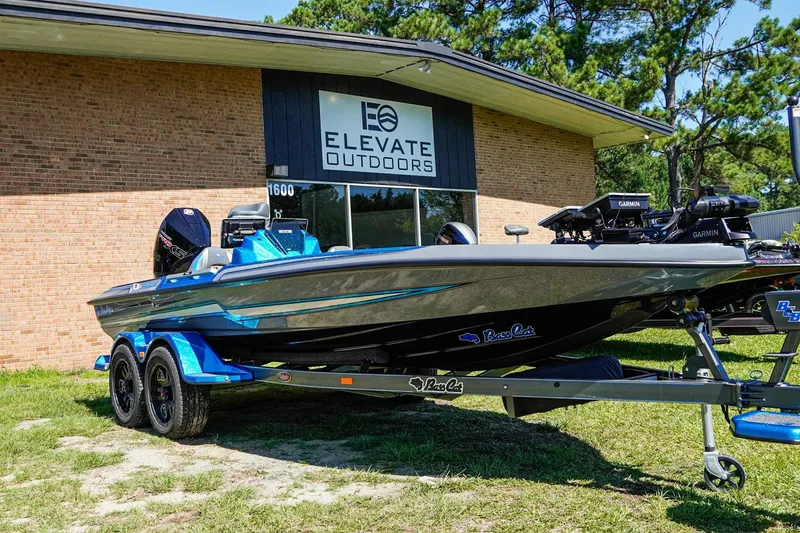 Slide: The Image of 2025 Bass Cat Puma STS boat displayed outside Elevate Outdoors building. - 3