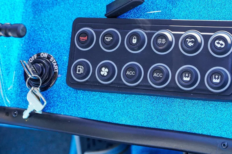 Slide: The Image of Control panel of 2025 Bass Cat Puma STS boat with ignition key and buttons. - 30