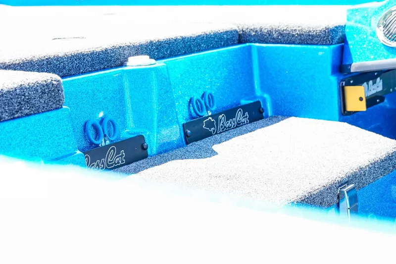 Slide: The Image of 2025 Bass Cat Puma STS boat interior with blue and gray seating and branding details. - 35