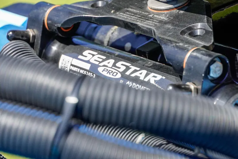 Slide: The Image of Close-up of SeaStar Pro hydraulic steering system on 2025 Bass Cat Puma STS boat. - 36