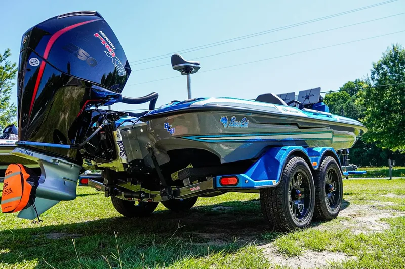 Slide: The Image of 2025 Bass Cat Puma STS boat with Mercury Pro XS engine on a grassy area. - 5