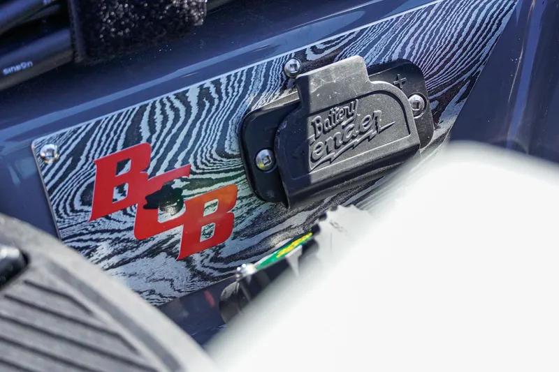 Slide: The Image of 2025 Bass Cat Puma STS detail with Battery Tender connector and BCB logo. - 52