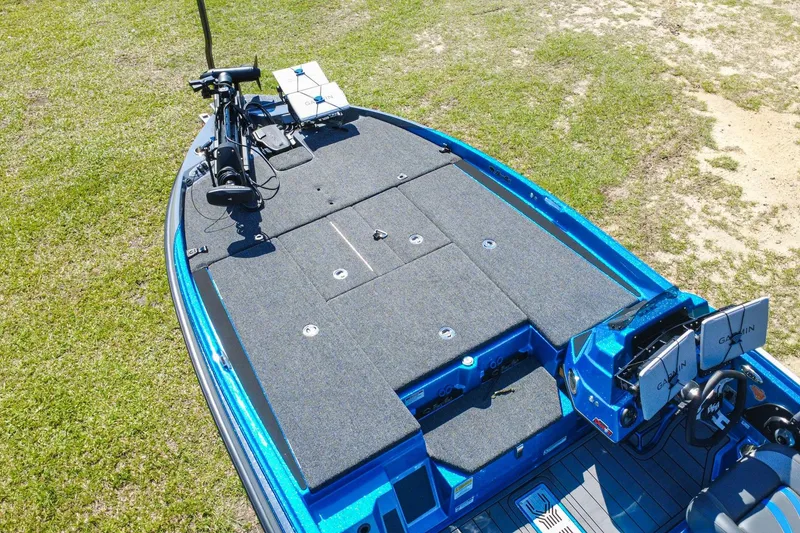 Slide: The Image of 2025 Bass Cat Puma STS boat with advanced Garmin electronics on grassy terrain. - 6