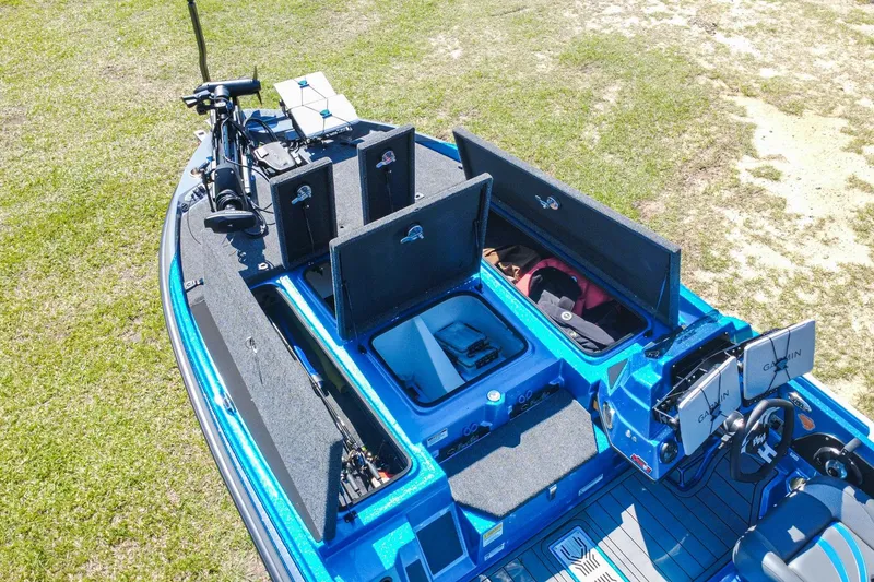 Slide: The Image of 2025 Bass Cat Puma STS boat with open storage compartments and Garmin electronics. - 7