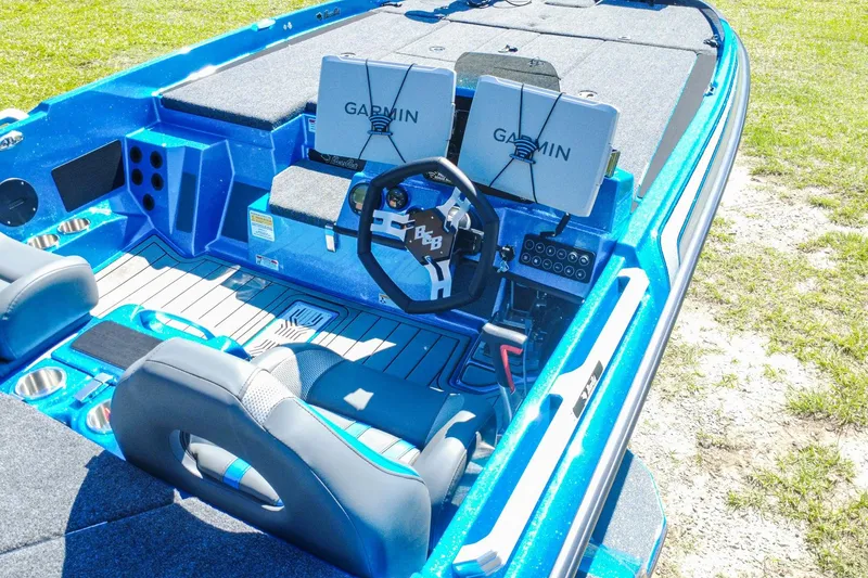 Slide: The Image of 2025 Bass Cat Puma STS boat interior with Garmin displays and steering wheel. - 8