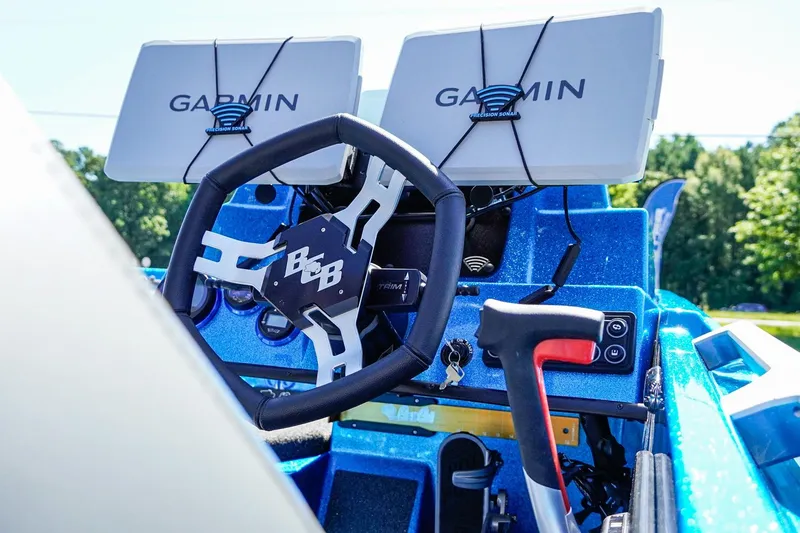 Slide: The Image of 2025 Bass Cat Puma STS boat dashboard with Garmin navigation systems. - 9