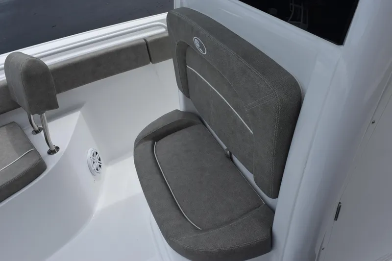 Slide: The Image of 2025 Sea Hunt Ultra 245 SE boat interior with gray cushioned seating. - 11