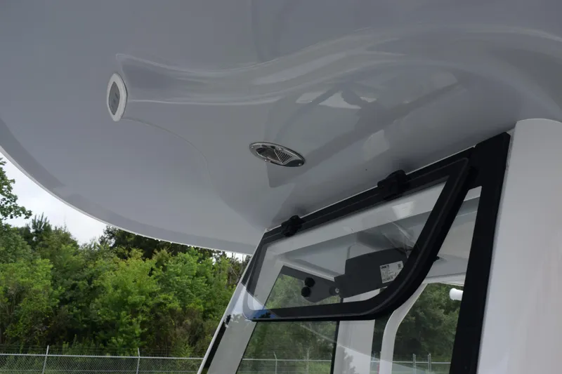 Slide: The Image of 2025 Sea Hunt Ultra 245 SE boat roof and window detail. - 12