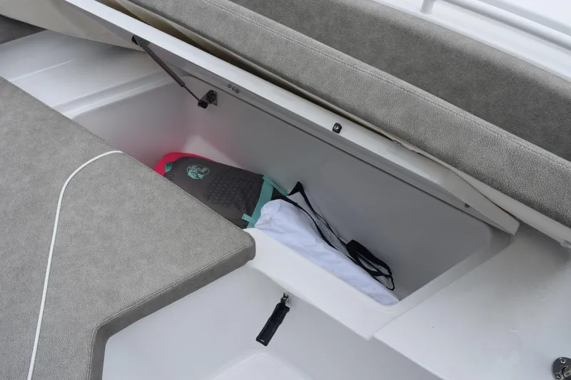 Slide: The Image of Storage compartment in 2025 Sea Hunt Ultra 245 SE boat with cushioned seating. - 17