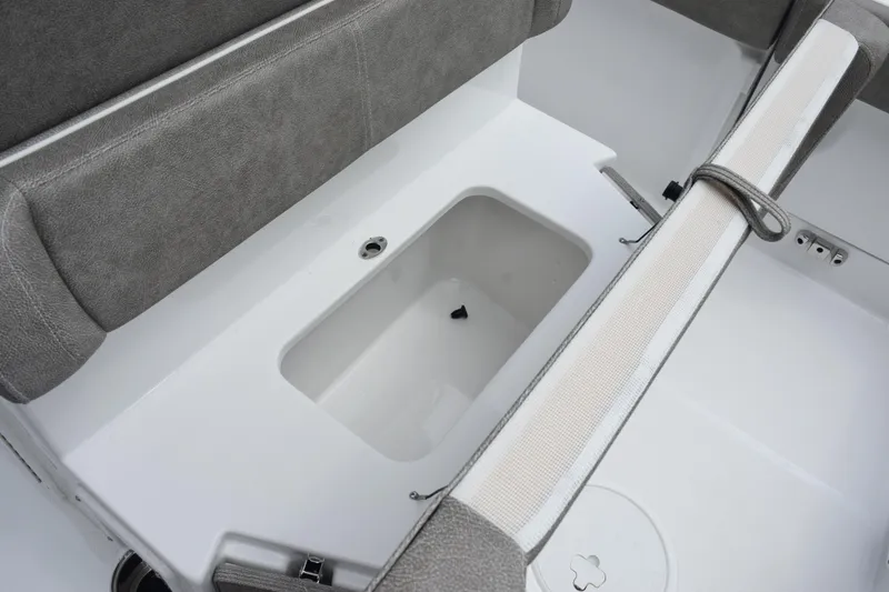 Slide: The Image of 2025 Sea Hunt Ultra 245 SE boat interior with storage compartment and seating. - 19