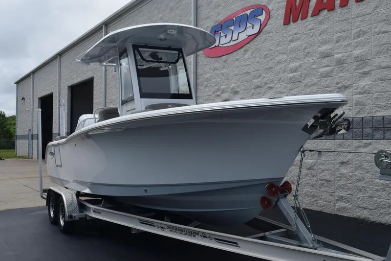 Slide: The Image of 2025 Sea Hunt Ultra 245 SE boat on trailer outside dealership. - 2