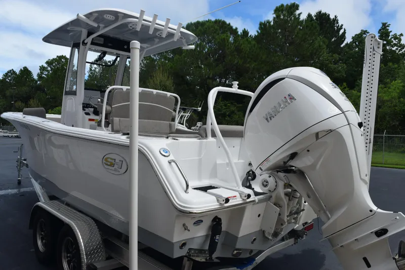 Slide: The Image of 2025 Sea Hunt Ultra 245 SE boat with Yamaha outboard motor on trailer. - 6