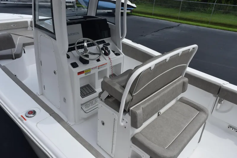 Slide: The Image of 2025 Sea Hunt Ultra 245 SE boat interior with steering console and seating. - 7