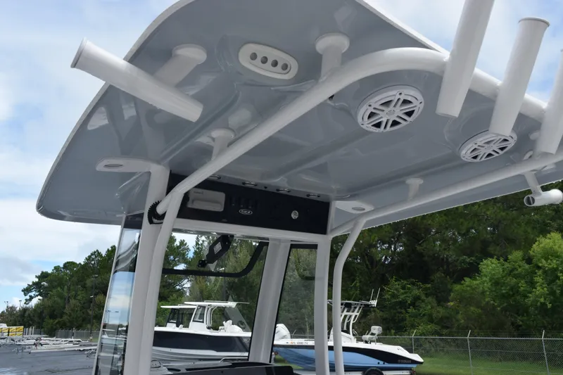 Slide: The Image of 2025 Sea Hunt Ultra 245 SE boat with T-top and rod holders. - 9