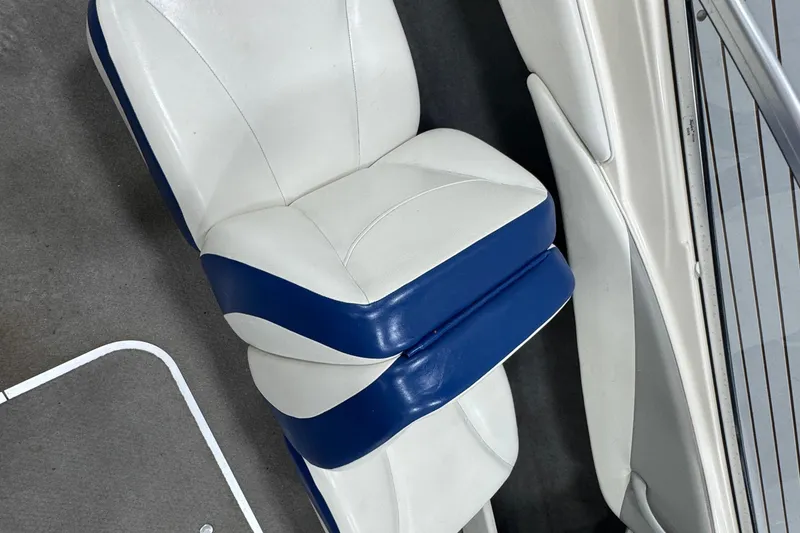 Slide: The Image of 2005 Bayliner 205 BR boat seat with white and blue upholstery. - 10