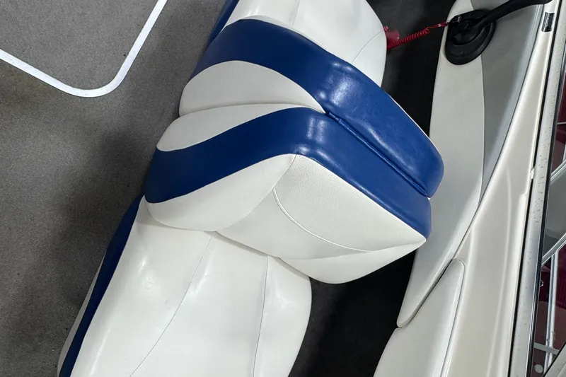 Slide: The Image of 2005 Bayliner 205 BR boat interior with blue and white seating. - 11