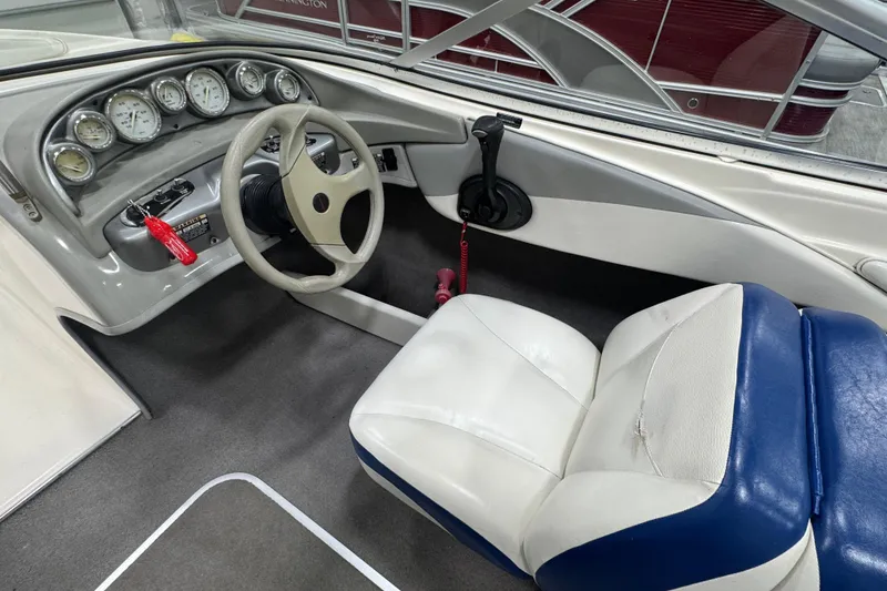 Slide: The Image of 2005 Bayliner 205 BR boat interior with steering wheel and dashboard gauges. - 15