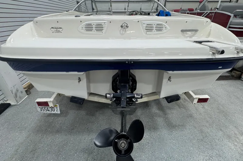 Slide: The Image of Rear view of a 2005 Bayliner 205 BR boat in a showroom. - 4