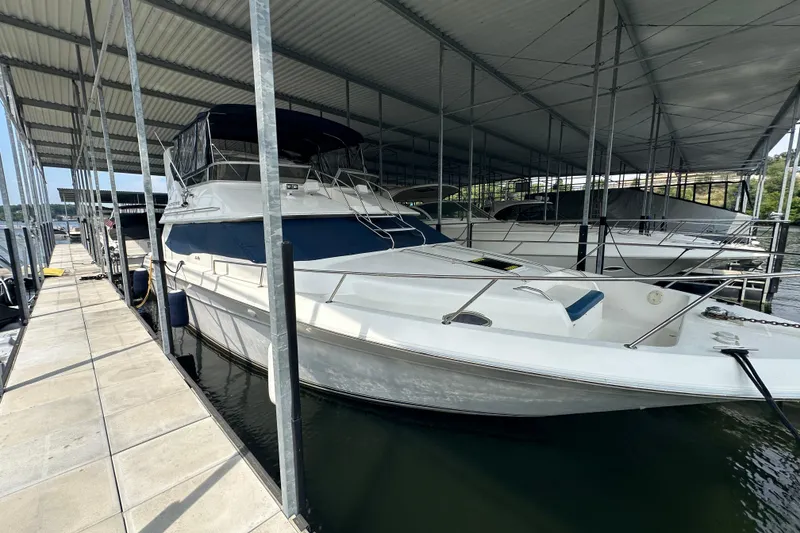 Slide: The Image of 1995 Sea Ray 440 Express Bridge docked under covered marina. - 12
