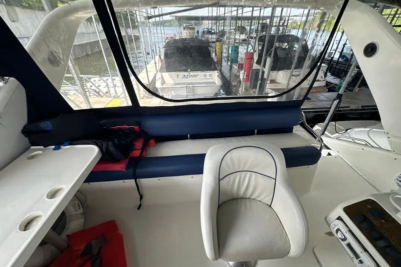 Slide: The Image of Interior view of 1995 Sea Ray 440 Express Bridge, featuring seating and helm area. - 21