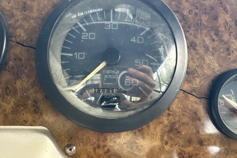Slide: The Image of Close-up of 1995 Sea Ray 440 Express Bridge RPM gauge on wooden dashboard. - 24