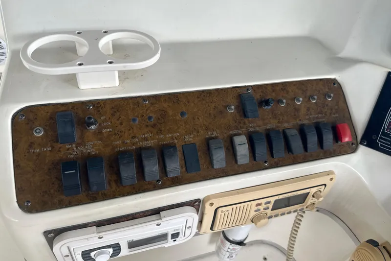 Slide: The Image of Control panel of a 1995 Sea Ray 440 Express Bridge boat with switches and radio. - 25