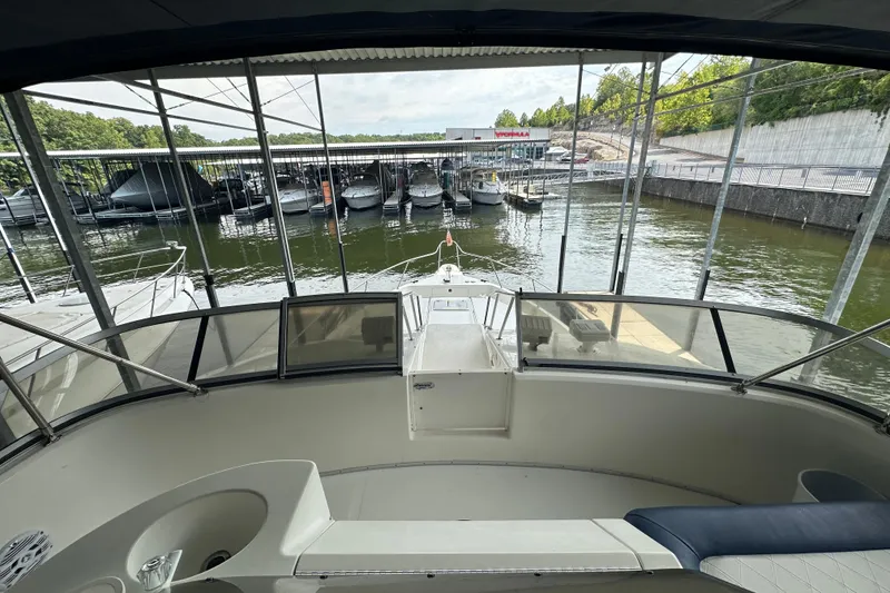 Slide: The Image of 1995 Sea Ray 440 Express Bridge yacht docked at marina, view from helm. - 26