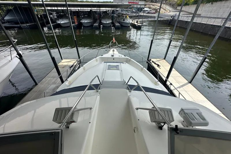 Slide: The Image of 1995 Sea Ray 440 Express Bridge yacht docked at marina, view from deck. - 27