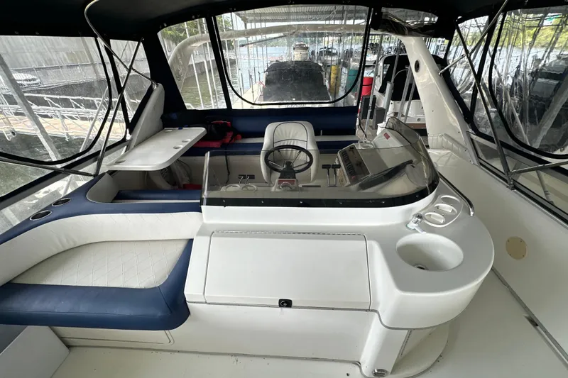 Slide: The Image of 1995 Sea Ray 440 Express Bridge cockpit with seating, helm, and covered canopy. - 31