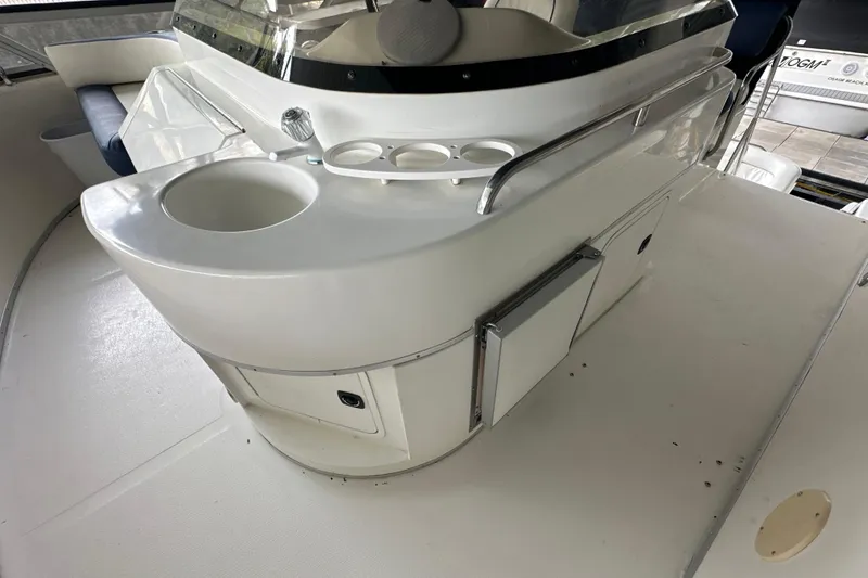 Slide: The Image of 1995 Sea Ray 440 Express Bridge interior with sink and storage compartments. - 32