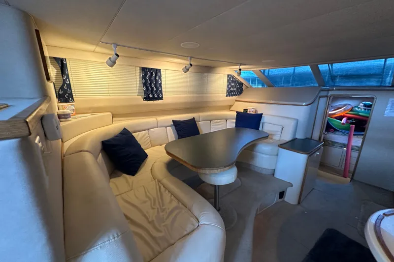 Slide: The Image of Luxurious interior of 1995 Sea Ray 440 Express Bridge with plush seating and elegant decor. - 36
