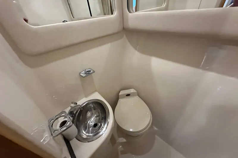 Slide: The Image of 1995 Sea Ray 440 Express Bridge bathroom with sink and toilet. - 40