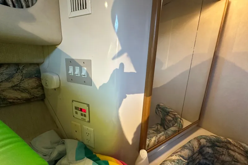 Slide: The Image of Interior of 1995 Sea Ray 440 Express Bridge with switches and mirror reflection. - 45