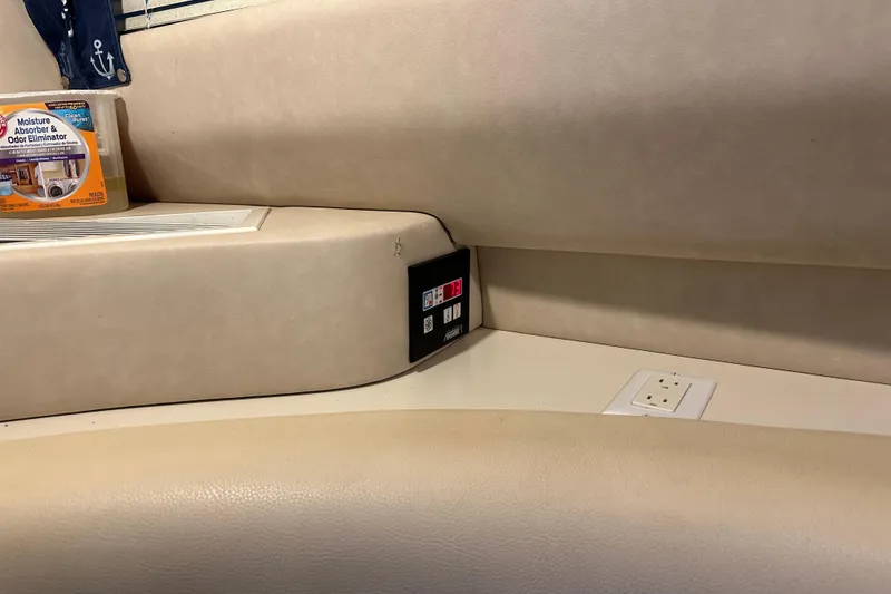 Slide: The Image of 1995 Sea Ray 440 Express Bridge interior with control panel and moisture absorber. - 49