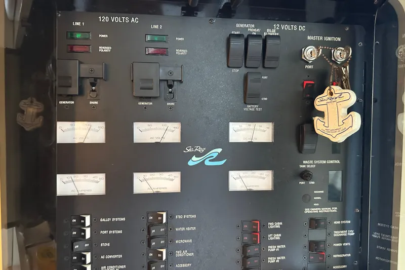 Slide: The Image of Control panel of a 1995 Sea Ray 440 Express Bridge boat with gauges and switches. - 51