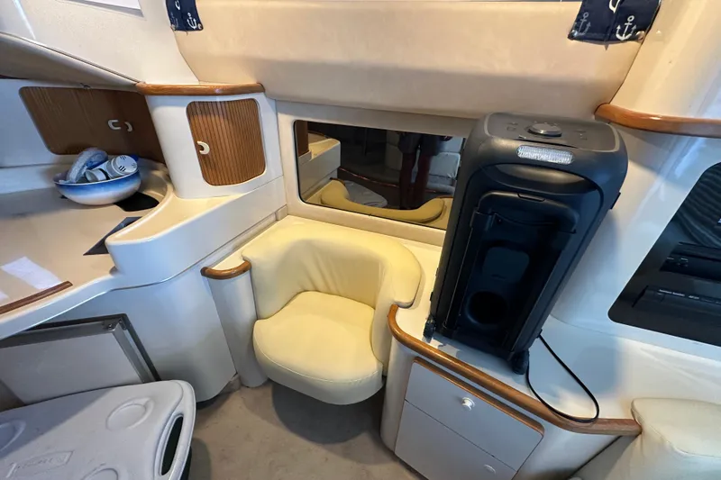 Slide: The Image of Interior of 1995 Sea Ray 440 Express Bridge with seating and storage. - 52