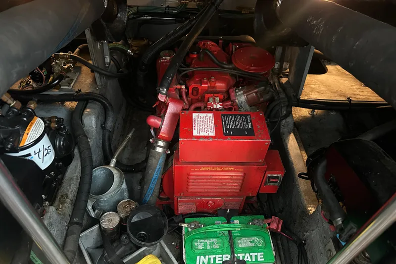 Slide: The Image of Engine compartment of a 1995 Sea Ray 440 Express Bridge with visible components and wiring. - 58