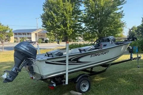 Slide: The Image of 2019 Starcraft Patriot boat on trailer with Yamaha outboard motor, parked on grass. - 3