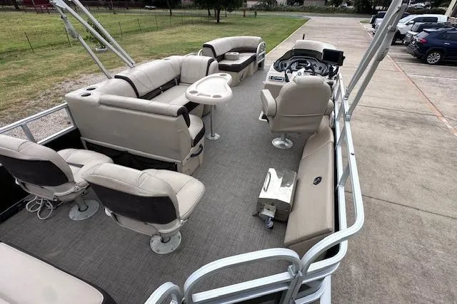 Slide: The Image of 2018 Sun Tracker SportFish 22 XP3 pontoon boat interior with seating and steering console. - 11