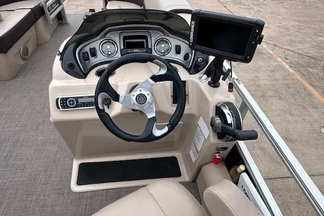 Slide: The Image of 2018 Sun Tracker SportFish 22 XP3 boat dashboard with steering wheel and navigation system. - 12