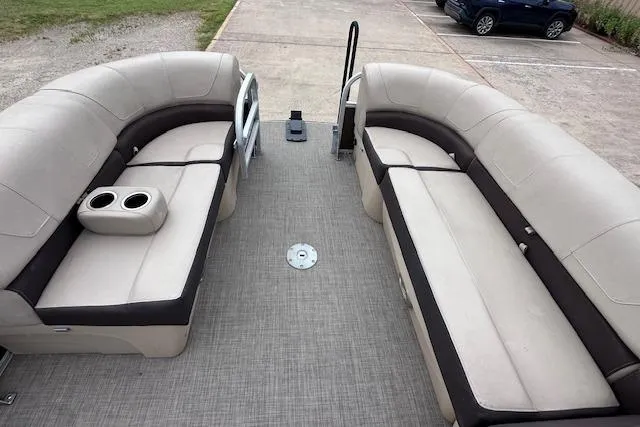 Slide: The Image of 2018 Sun Tracker SportFish 22 XP3 pontoon boat interior with beige seating and cup holders. - 14